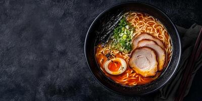 Ramen bowl with thick broth, noodles, and meat slices on a flat surface, food setting photo