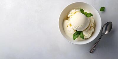 Bowl with a single scoop of ice cream, served with a small spoon resting nearby, food setting photo