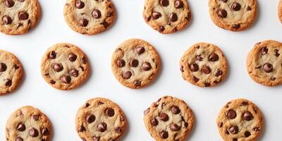 Group of chocolate chip cookies neatly arranged on a flat surface, food setting photo