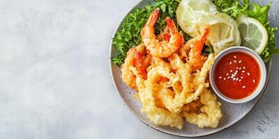 Plate of tempura vegetables and shrimp with dipping sauce, food setting photo