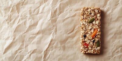 Single energy bar with grains and seeds on parchment paper, food setting photo