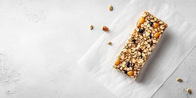 Single energy bar with grains and seeds on parchment paper, meal photography photo