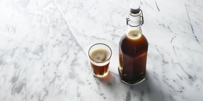 Nitro coffee in a glass bottle on a marble countertop with a small glass beside it, culinary photography photo