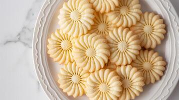 Shortbread cookies arranged in a circular pattern on a white plate, food photography photo