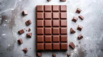 Unwrapped milk chocolate bar with a smooth surface, neatly divided into even rectangular pieces, gastronomy photography photo