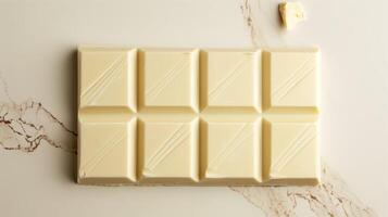 Unwrapped white chocolate bar with distinct lines separating individual segments, gastronomy photography photo