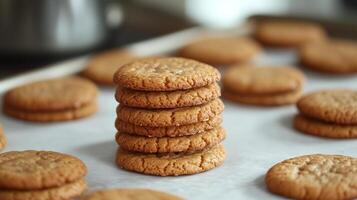 Stack of round, evenly baked cookies on a parchment paper-lined tray, meal photography photo