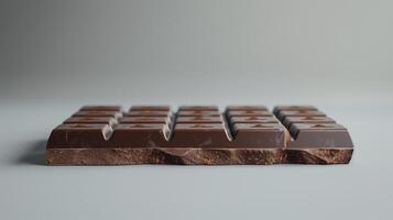 Side view of a chocolate bar showing thickness and consistent, unblemished surface appearance, meal photography photo