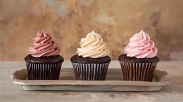Three cupcakes with even frosting, placed side by side on a simple serving tray, food setting photo