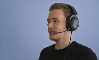 Man working with headphones and microphone. Support service operator talking with a client. Call center telemarketing and customer support conception photo