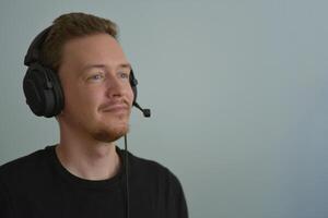 Man working with headphones and microphone. Support service operator talking with a client. Call center telemarketing and customer support conception photo