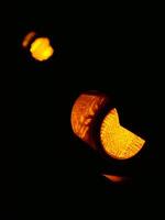 Yellow traffic light close up in the dark on a black background photo