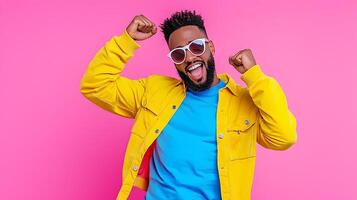 Energetic Man Expressing Excitement with Dab Pose on Pink Background photo
