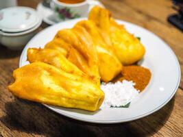 Fried bananas or fried bananas with toppings that are separated from powdered sugar and brown sugar. photo