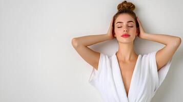 Radiant Woman in Soft Spa Robe Enjoying Peaceful Relaxation on White Background photo