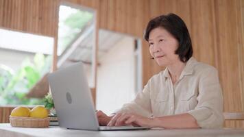 Focused middle-aged woman sit at desk, using laptop, looking pensive or concerned, learn new application, looks at device screen, learn received e-mail, ponder on task, doing on-line job, Business. video