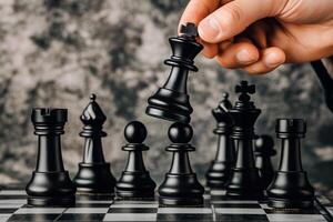 Hand of player moving a black king chess piece on a chess board during an intense game, focusing on strategy and competition in the world of chess. photo