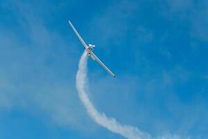 Stunt aerobatic plane performing stunts in air photo