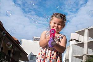 The child blows bubbles. photo