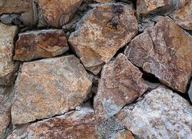 texture of stones on the ground gray and orange. stone background photo