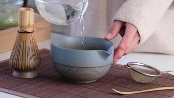 Step by step tutorial making Japanese matcha tea. Step two , adding hot water and whisk video