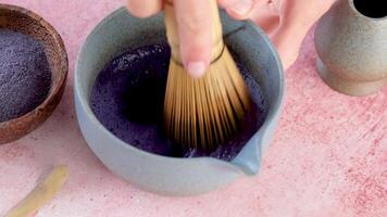 Step by step tutorial making blue matcha tea. Step three , whisking blue matcha powder until froth video