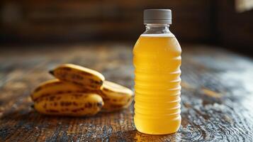 A vibrant banana beverage sits next to fresh, speckled bananas in warm light photo