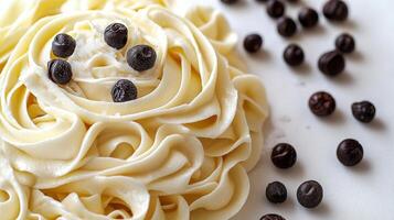 Delicate swirl of creamy pasta topped with rich chocolate drops on a pristine surface in a cozy kitchen setting photo