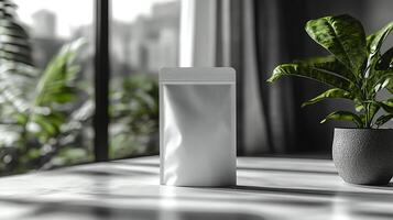 Minimalist packaging on a sunlit table with green plants in a modern indoor environment during the afternoon photo