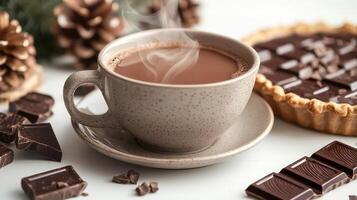 Warm chocolate drink with chocolate tart and pinecones on a winter table adorned with festive decorations photo