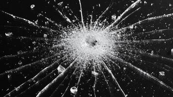 Glass fragments scatter from a center, forming a complex pattern of destruction photo
