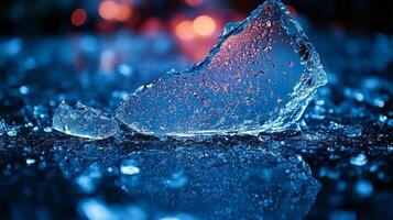 A stunning ice shard glimmers on a reflective surface, lit by soft blue tones and twinkling lights photo