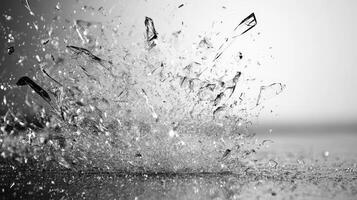 A striking burst of water and shards captivates in black and white simplicity photo
