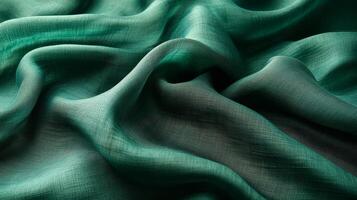 Luxurious green fabric cascades beautifully, capturing light and creating gentle shadows photo