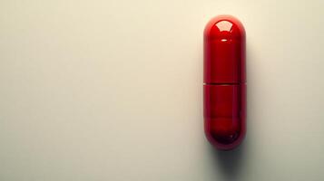 A bold red capsule lies on a clean white surface, evoking questions about its purpose and effects photo