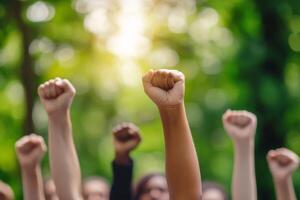 In a green park, a diverse group raises their fists in solidarity during a peaceful protest, symbolizing unity, strength, and hope for a brighter future where all thrive and embrace change photo