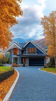 The stunning and beautiful house is surrounded by vibrant and colorful autumn foliage, with a wellmaintained yard that features an inviting and aesthetically pleasing driveway that welcomes you photo