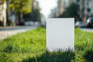 Blank white sign on grass in city photo