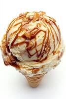Indulge in a delightful single scoop of incredibly rich caramel swirl ice cream, boasting a smooth and creamy texture along with a delectable caramel flavor, all served perfectly in a crispy cone photo