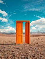 In the vastness of the open desert, a vibrant orange door stands solitary, bathed in the light of the bright blue sky above, stirring feelings of curiosity and wonder deep within the observers mind photo