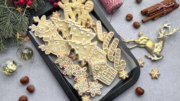 Christmas cookies with white icing displayed on a black baking sheet video
