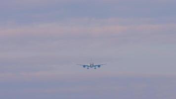 Passenger unknown plane approaching landing. Plane in the sky, front view video