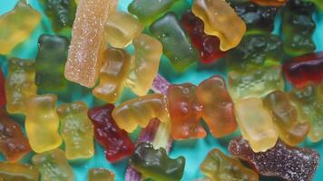 A delightful assortment of colorful gummy bears arranged on a vibrant, eyecatching background video