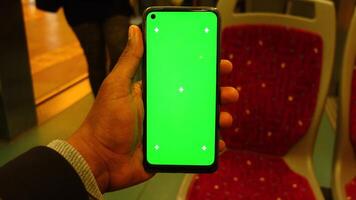 young man hand using smart phone with green screen inside of metro train video