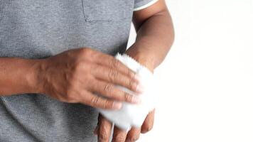 man disinfecting his hands with a wet wipe. video