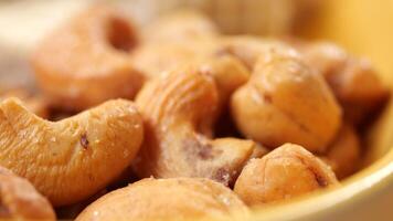 cashew nuts in a small bowl on black color background video
