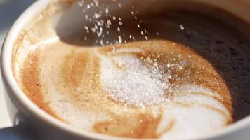 white sugar pouring from a in a paper packet on a coffee cup video