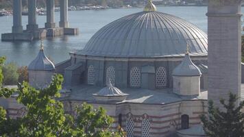 A Beautiful Mosque Featuring a Dome and a Minaret Overlooking the Water video