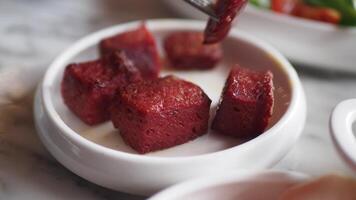 Close-Up View Of Fork Slicing Into Tasty Slices Of Sausage On Plate video