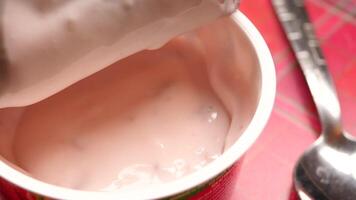 Delicious Pink Yogurt Served in an Open Container Accompanied by a Spoon video
